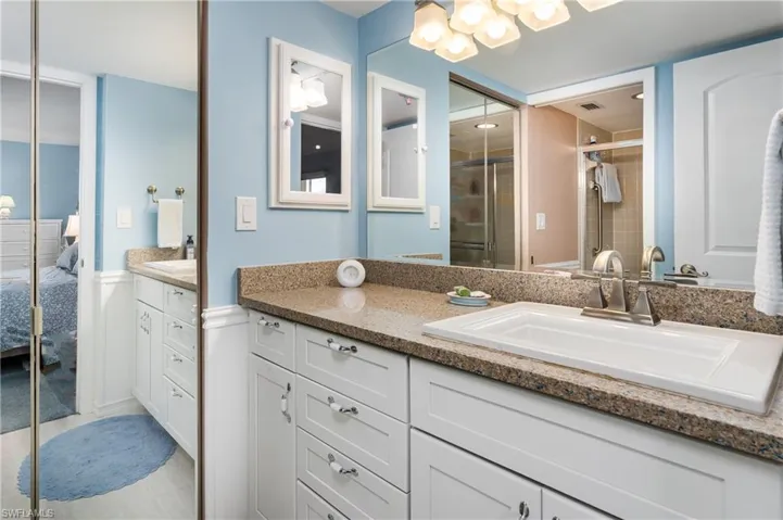 Bathroom with walk in closet and vanity