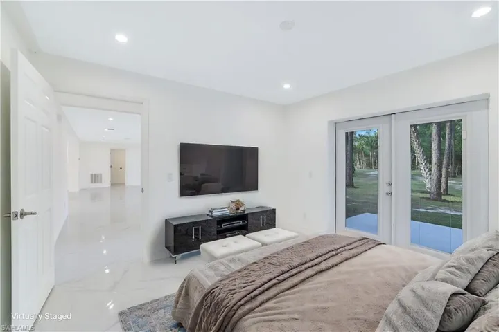 Staged 1st floor Bedroom with access to exterior and french doors