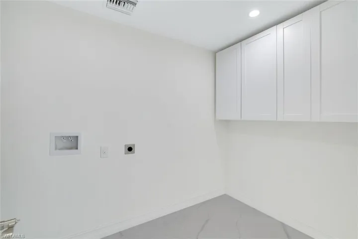 Washroom featuring cabinets, hookup for a washing machine, and  dryer