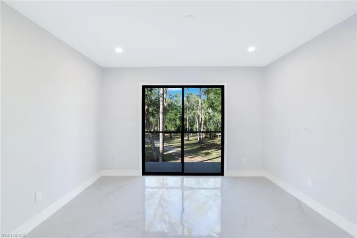 2nd floor bedroom featuring a view of wooded area