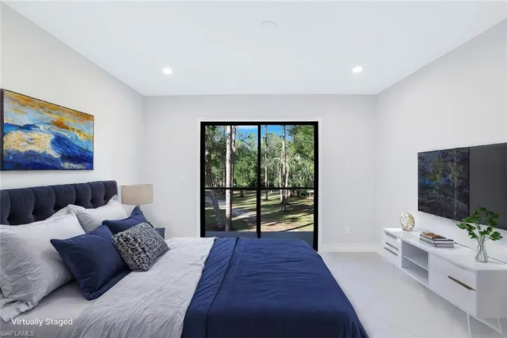 Staged 2nd floor Bedroom with view of wooded area