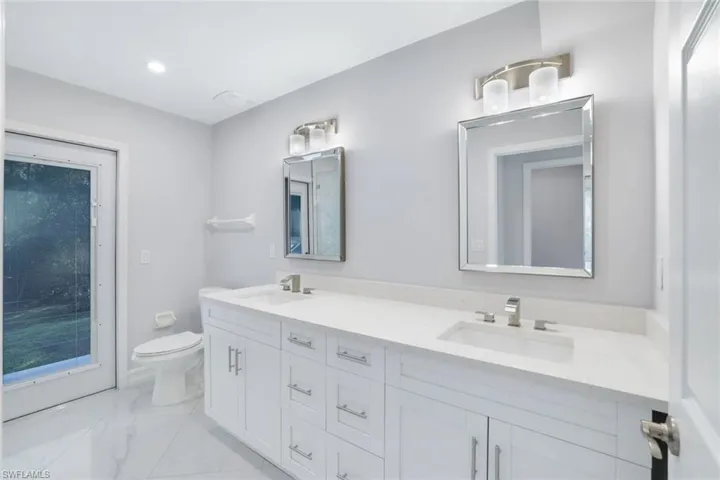 2nd floor bathroom featuring a double sink and cabana bath