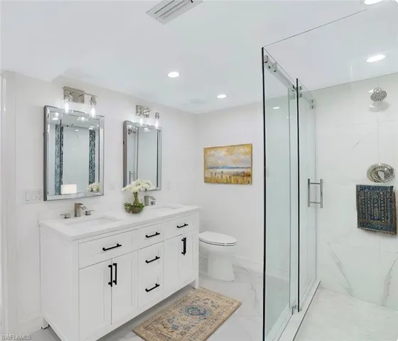 Staged 1st floor bathroom featuring vanity, toilet, and a shower