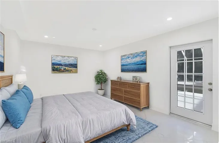 Staged 1st floor bedroom with frenchdoor to the pool