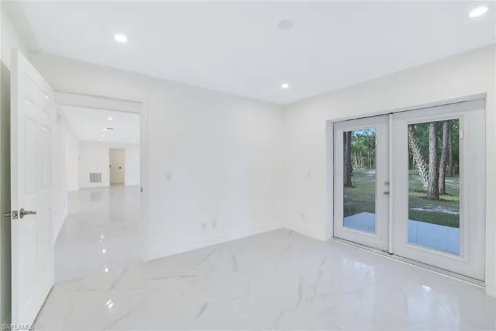 Unfurnished 1st floor room featuring french doors