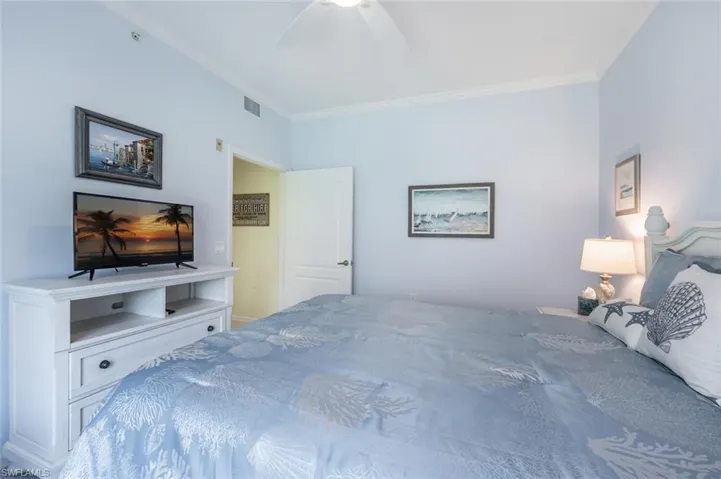 Bedroom featuring ceiling fan and crown molding