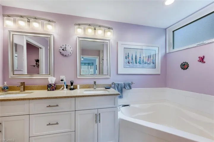 Bathroom with vanity and a bath