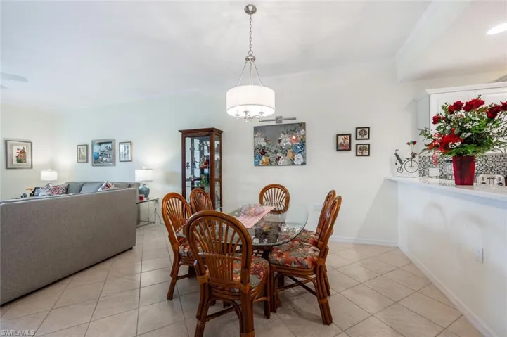 Tiled dining space with crown molding