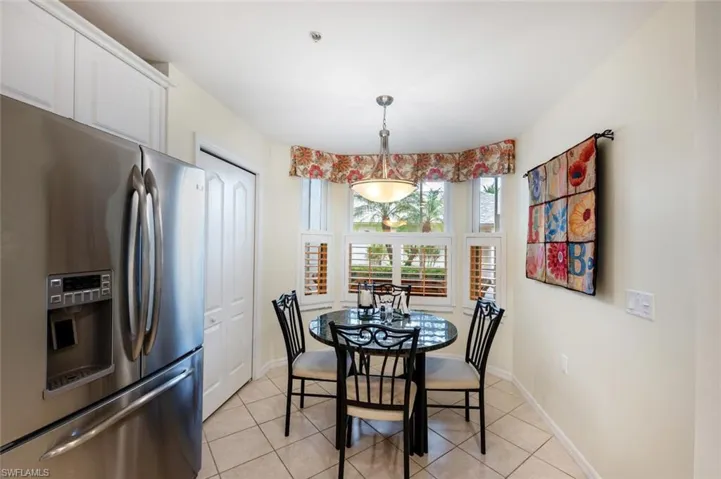 Dining space with light tile patterned flooring