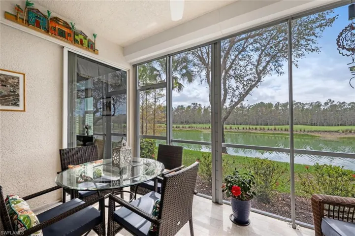 Sunroom featuring a water view