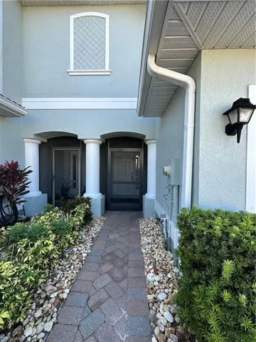 Doorway to property with stucco siding