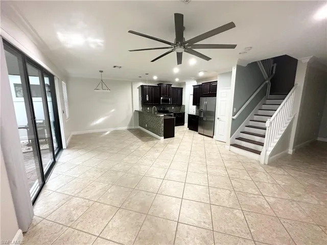 Kitchen featuring a peninsula, appliances with stainless steel finishes, dark cabinets, ceiling fan, and recessed lighting