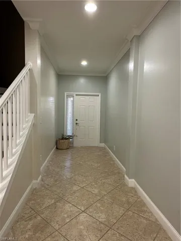 Entryway with ornamental molding and recessed lighting