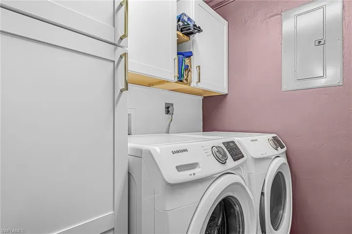 Laundry room with upgraded electric panel, cabinet space, washer and clothes dryer