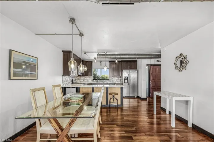 Dining area with wood-style floors and baseboards