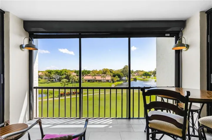 Lanai with a water view and golf course view