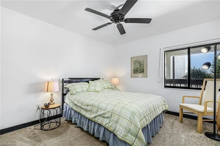Bedroom with light colored carpet and ceiling fan