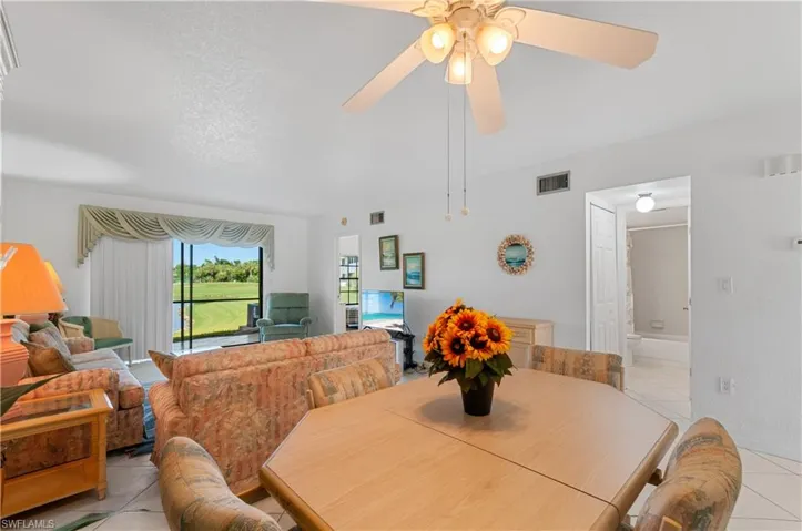 Dining area with light tile patterned floors and ceiling fan