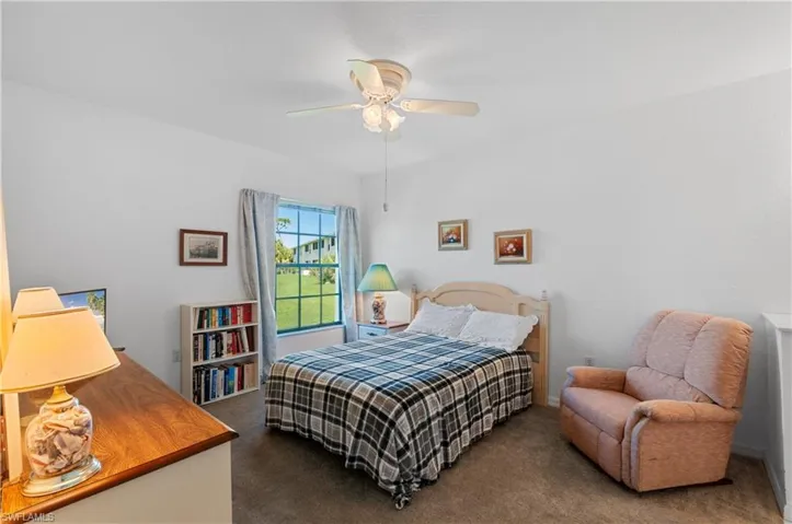 Bedroom featuring ceiling fan and carpet flooring