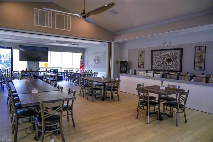 Dining space with ceiling fan, light wood-type flooring, and lofted ceiling