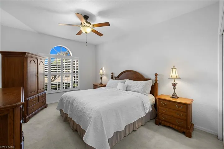 Bedroom featuring light colored carpet and a ceiling fan