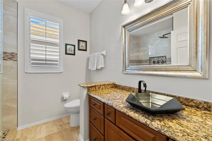Bathroom with vanity and a tile shower