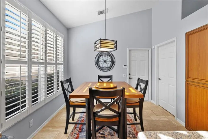 Dining area with baseboards and high vaulted ceiling