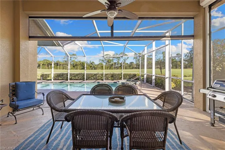 View of patio with outdoor dining space, an outdoor pool, a lanai, a sunroom, and area for grilling