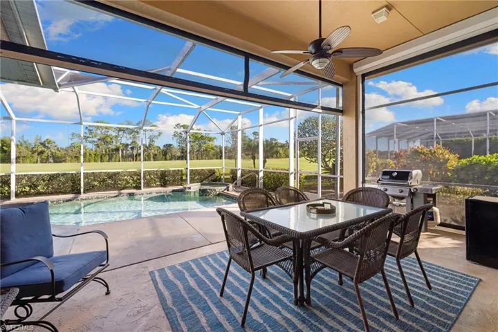 View of patio / terrace with glass enclosure, a sunroom, and grilling area