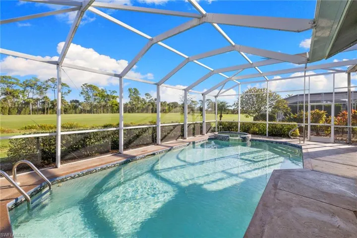 View of pool with a lanai, a sunroom, a pool with connected hot tub, and a patio