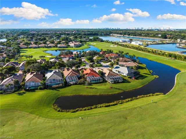 Drone / aerial view of a local golf course and a nearby body of water
