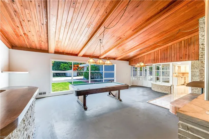 Rec room featuring billiards, lofted ceiling with beams, concrete flooring, and wooden ceiling