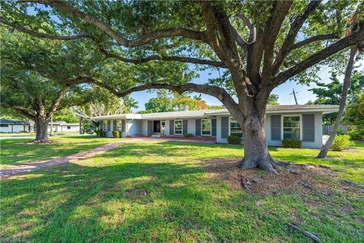 Ranch-style home featuring a front yard