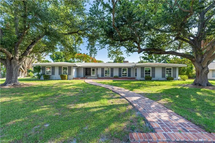 Ranch-style home featuring a front yard