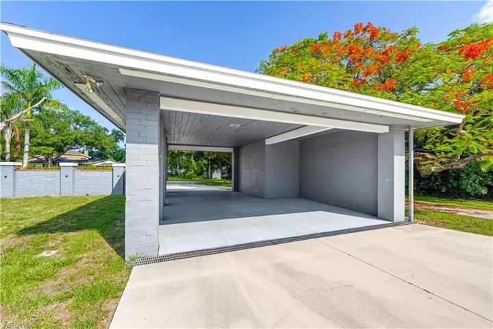 Garage with a yard and a carport