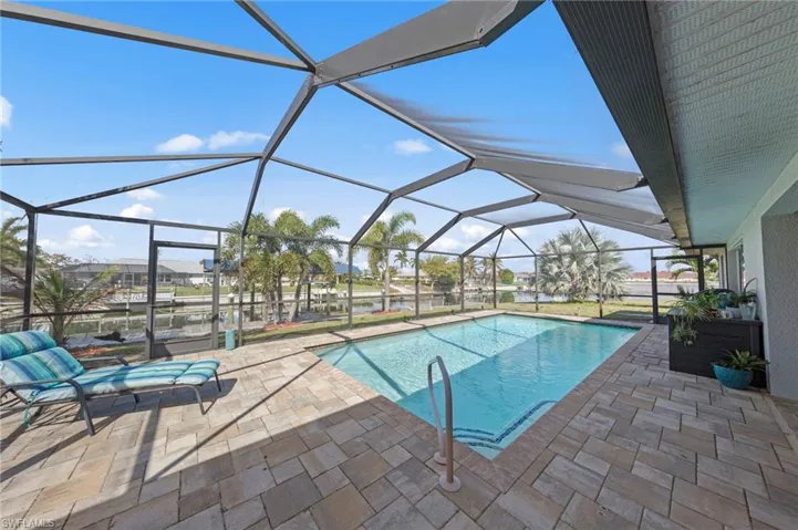 Swimming pool with a lanai, a sunroom, and a patio