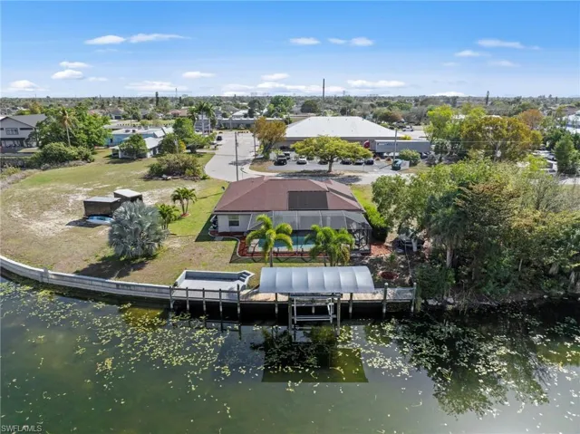 Aerial perspective of suburban area featuring a nearby body of water