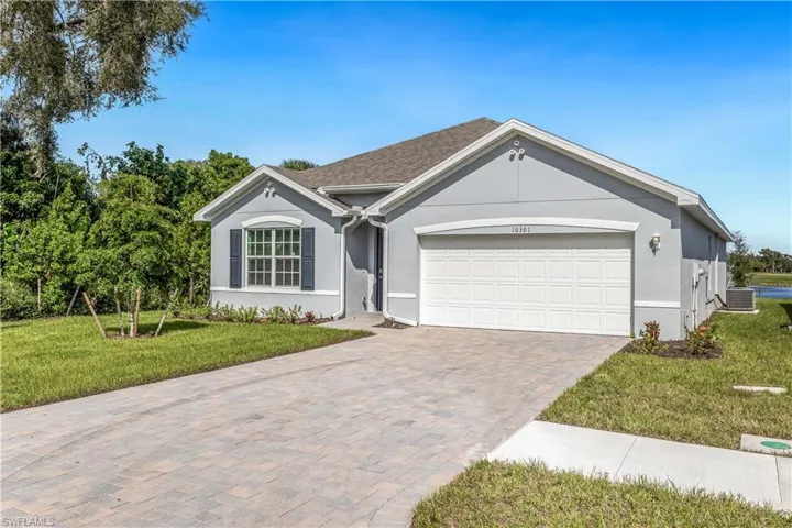 Single story home featuring cooling unit, a front yard, and a garage