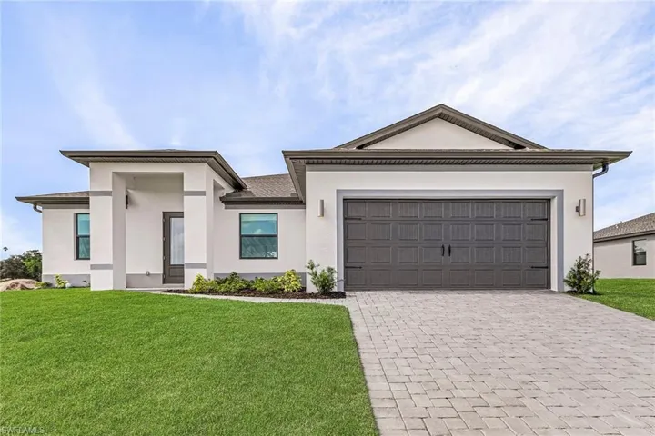View of front facade with a front yard and a garage