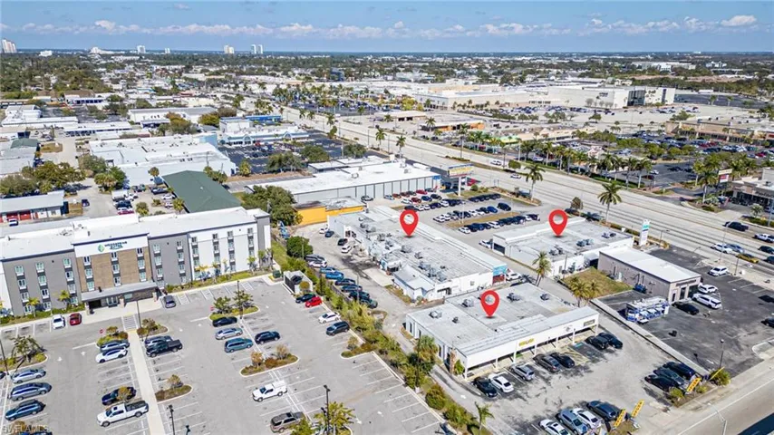 Aerial view of property's location featuring a commercial area