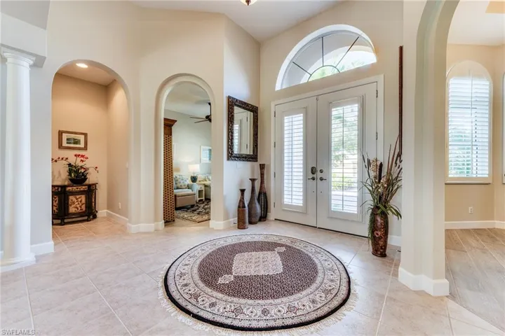 Formal entry with den on left and dining room on right