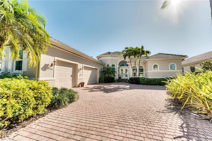 Estate home with a long paver stone driveway