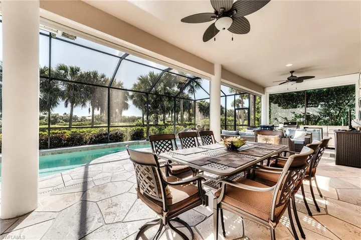 Outdoor dining area with kitchen in background