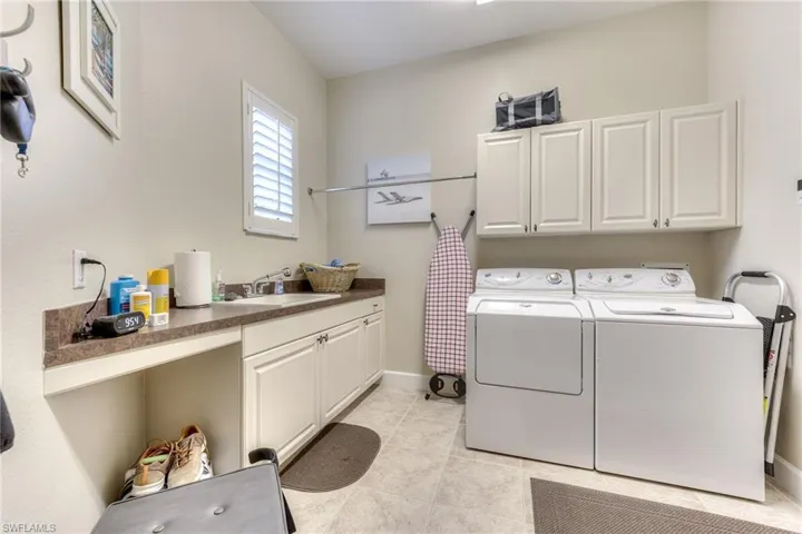 Large laundry room adjacent to garage and bedroom 2