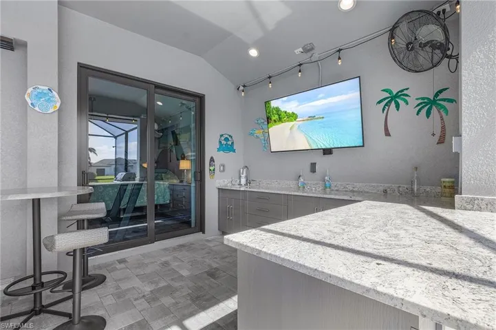Bathroom featuring vanity and vaulted ceiling