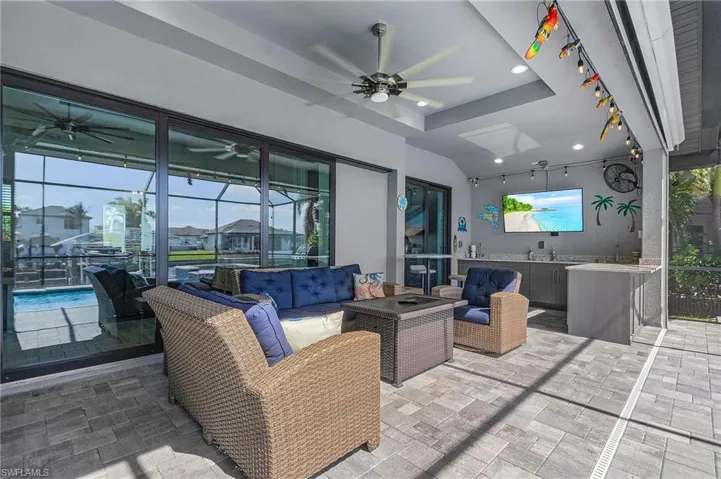 View of patio with ceiling fan and an outdoor hangout area