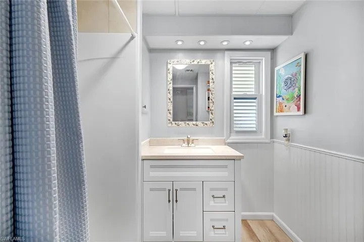 Updated guest bathroom featuring modern vanity, stylish finishes, and walk-in shower.