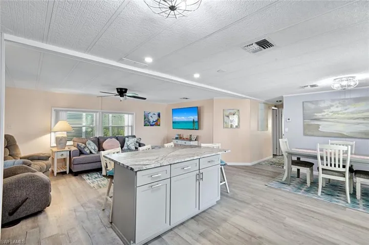 Expansive view of the kitchen, dining, and living areas showcasing the home's desirable open floor plan.