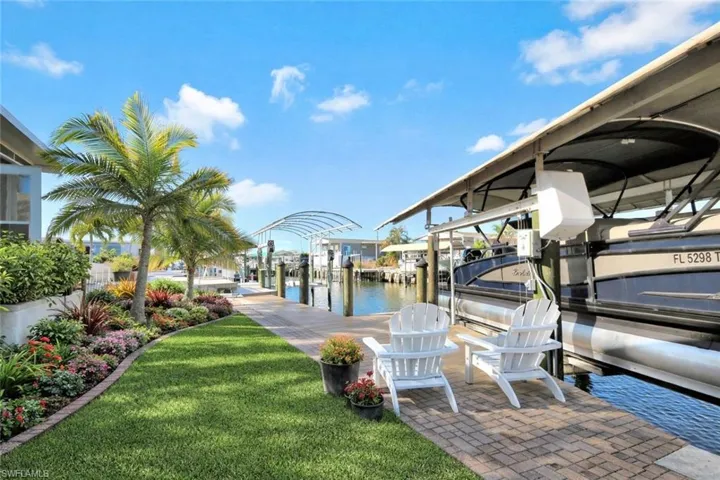 Waterfront patio overlooking the canal, creating the perfect space to relax, entertain, and enjoy the Florida boating lifestyle. *AI enhanced