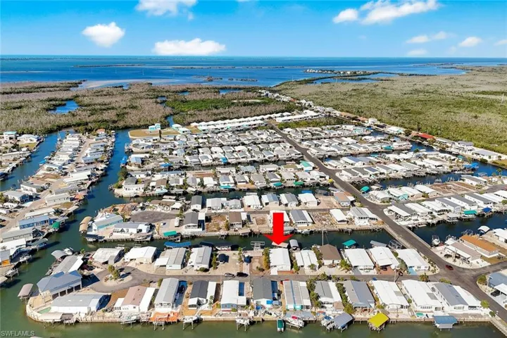 Final aerial view highlighting the canal-front setting, surrounding waterways, and easy Gulf boating access.